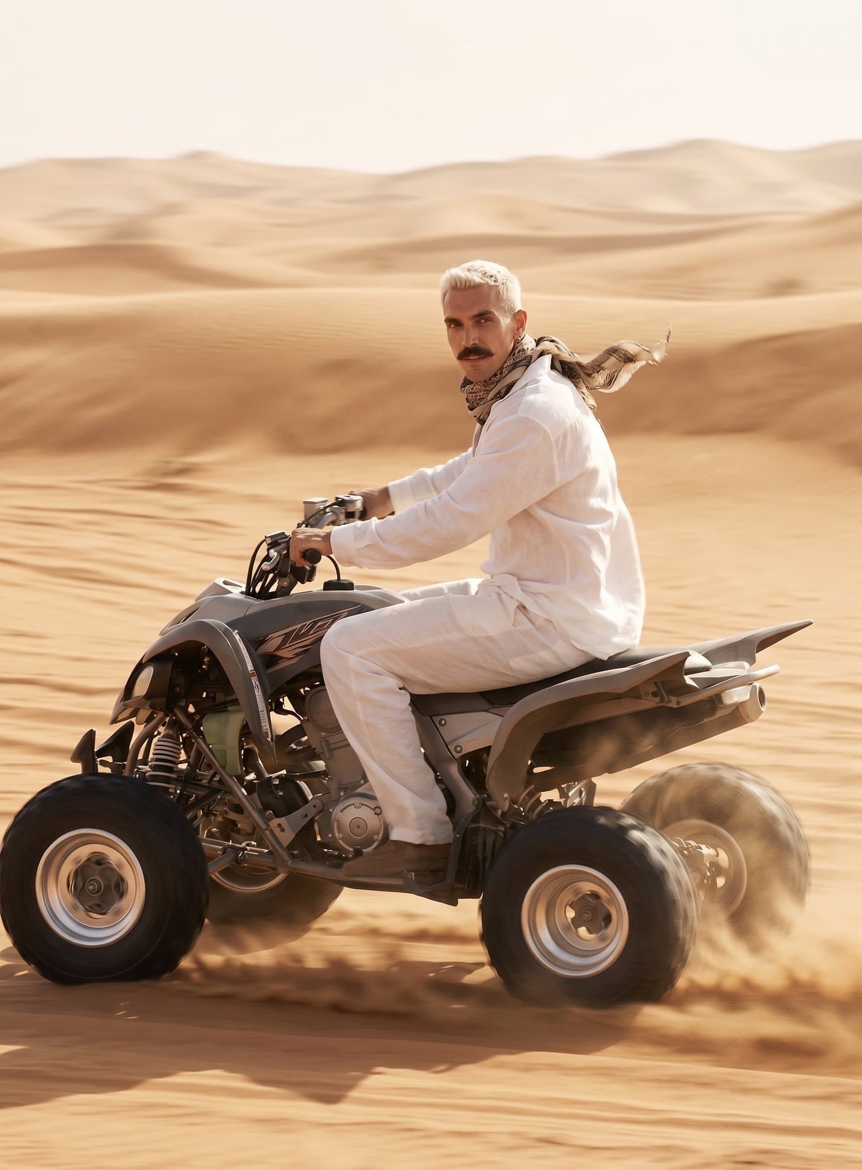 A man races across the endless desert dunes on an
