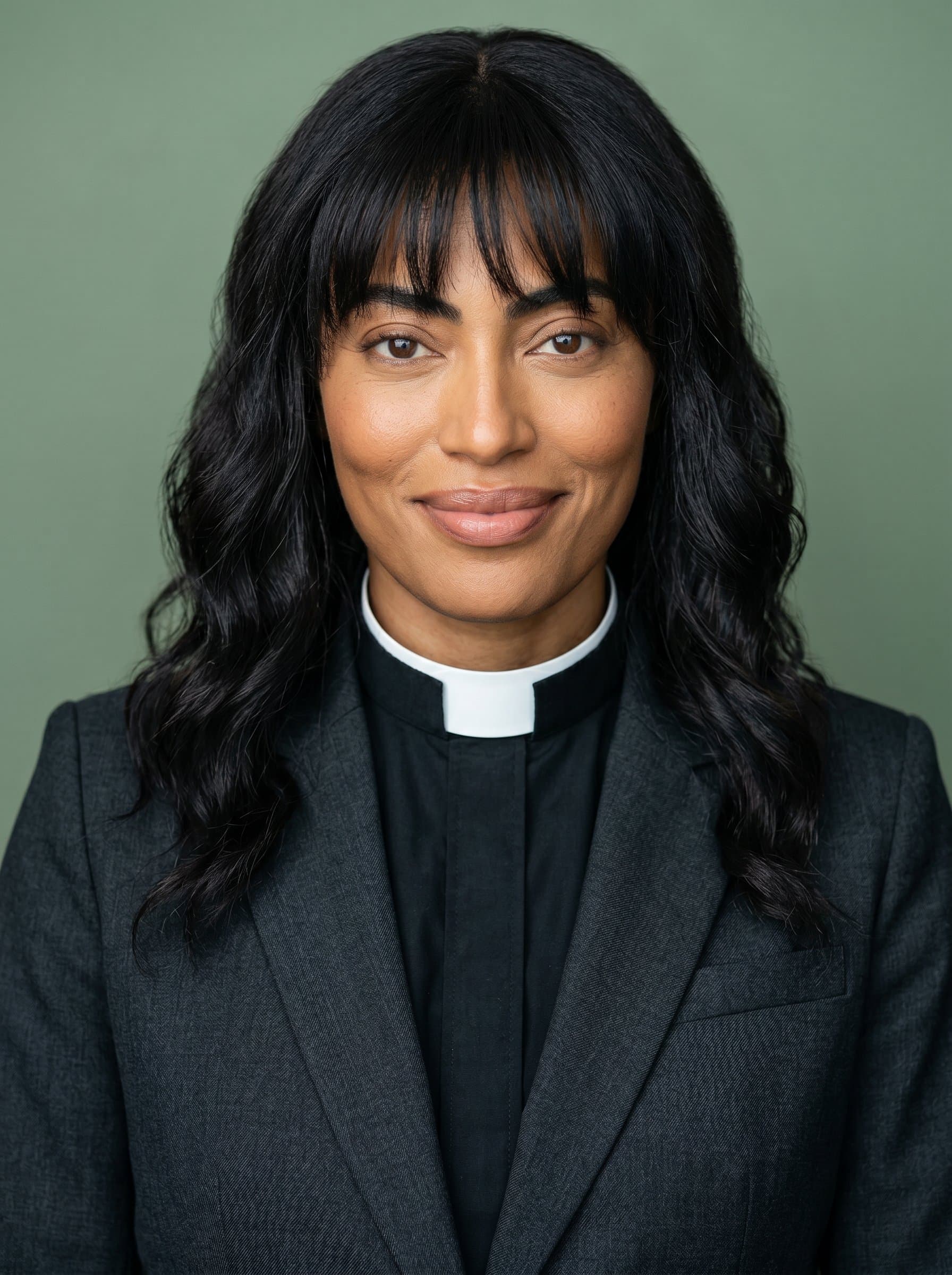 : A professional headshot of a pastor with a carin